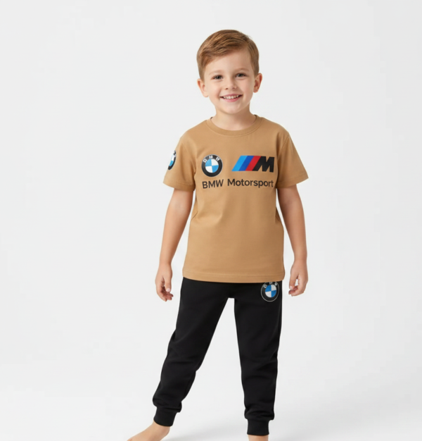 Toddler boy modeling a camel-colored BMW Motorsport short-sleeve t-shirt and black jogger pants tracksuit.