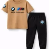 Toddler boy modeling a camel-colored BMW Motorsport short-sleeve t-shirt and black jogger pants tracksuit.
