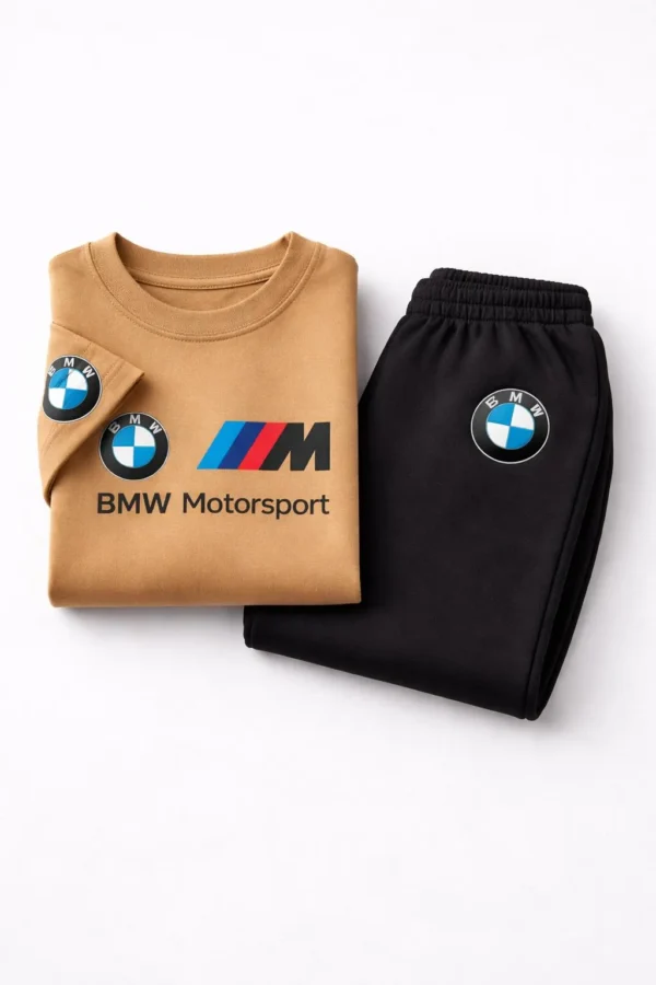 Toddler boy modeling a camel-colored BMW Motorsport short-sleeve t-shirt and black jogger pants tracksuit.